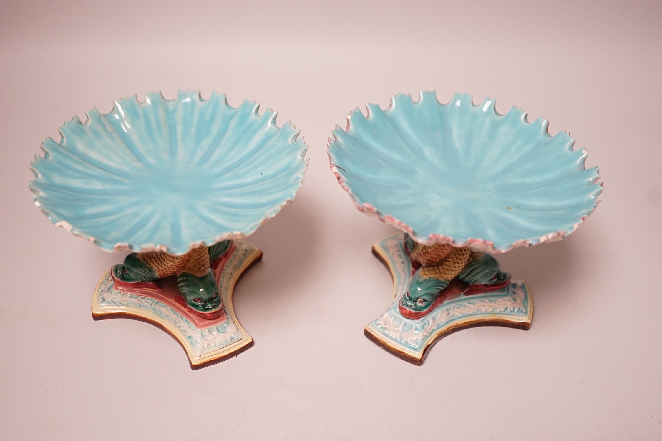A pair of late 19th century Royal Worcester majolica dolphin comports, 10cm tall